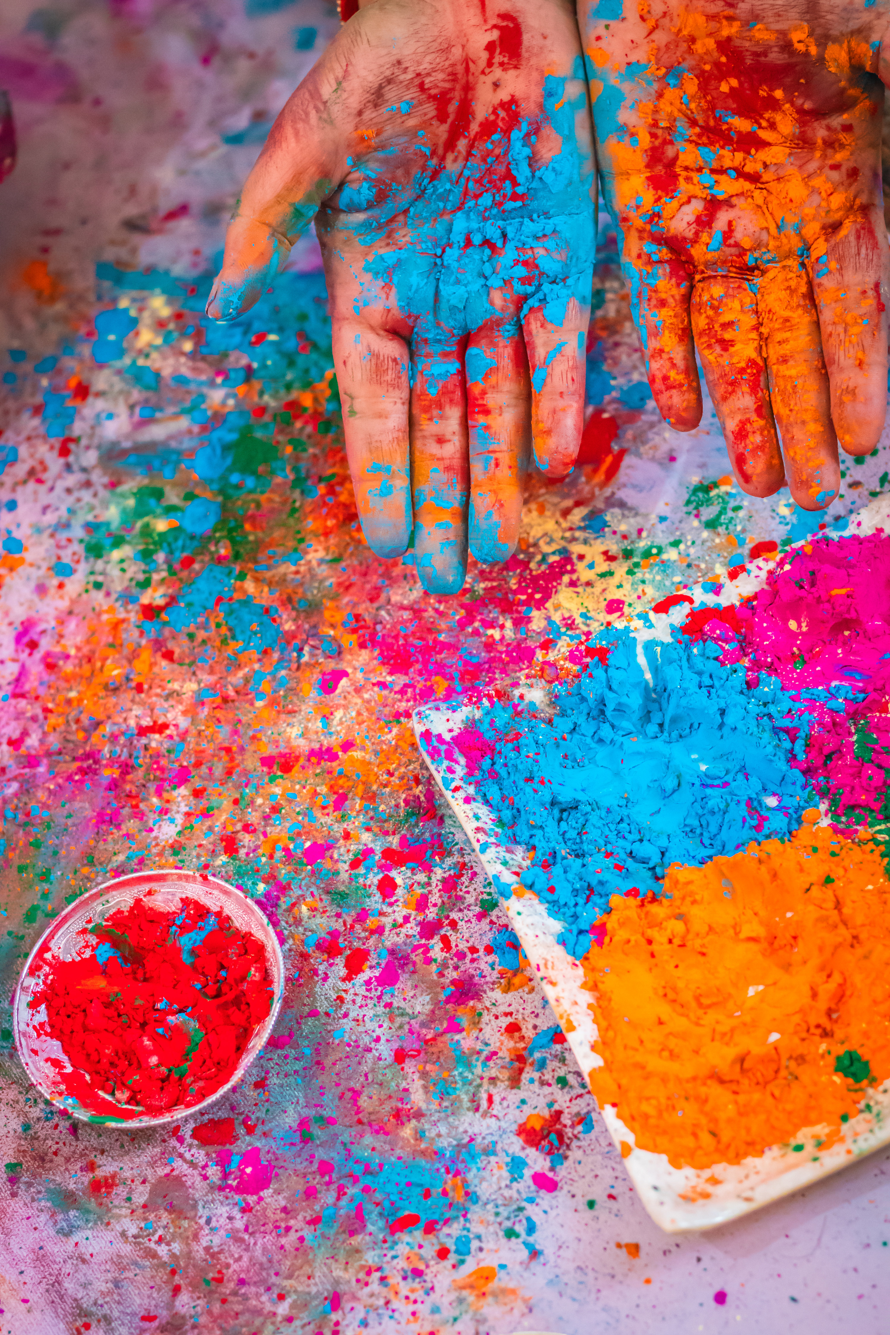 Colorful hand at Holi celebration with multicolor from flat angle