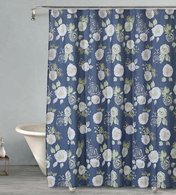 the blue shower curtain with a floral pattern in a bathroom