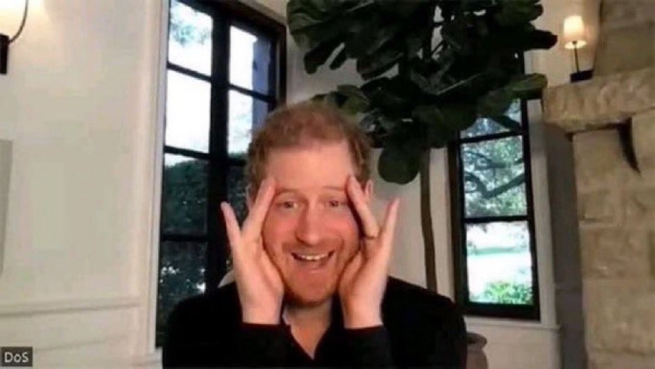 Prince Harry cupping his face