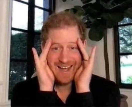 Prince Harry cupping his face