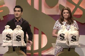 Two people with giant bags of cash debt in front of them