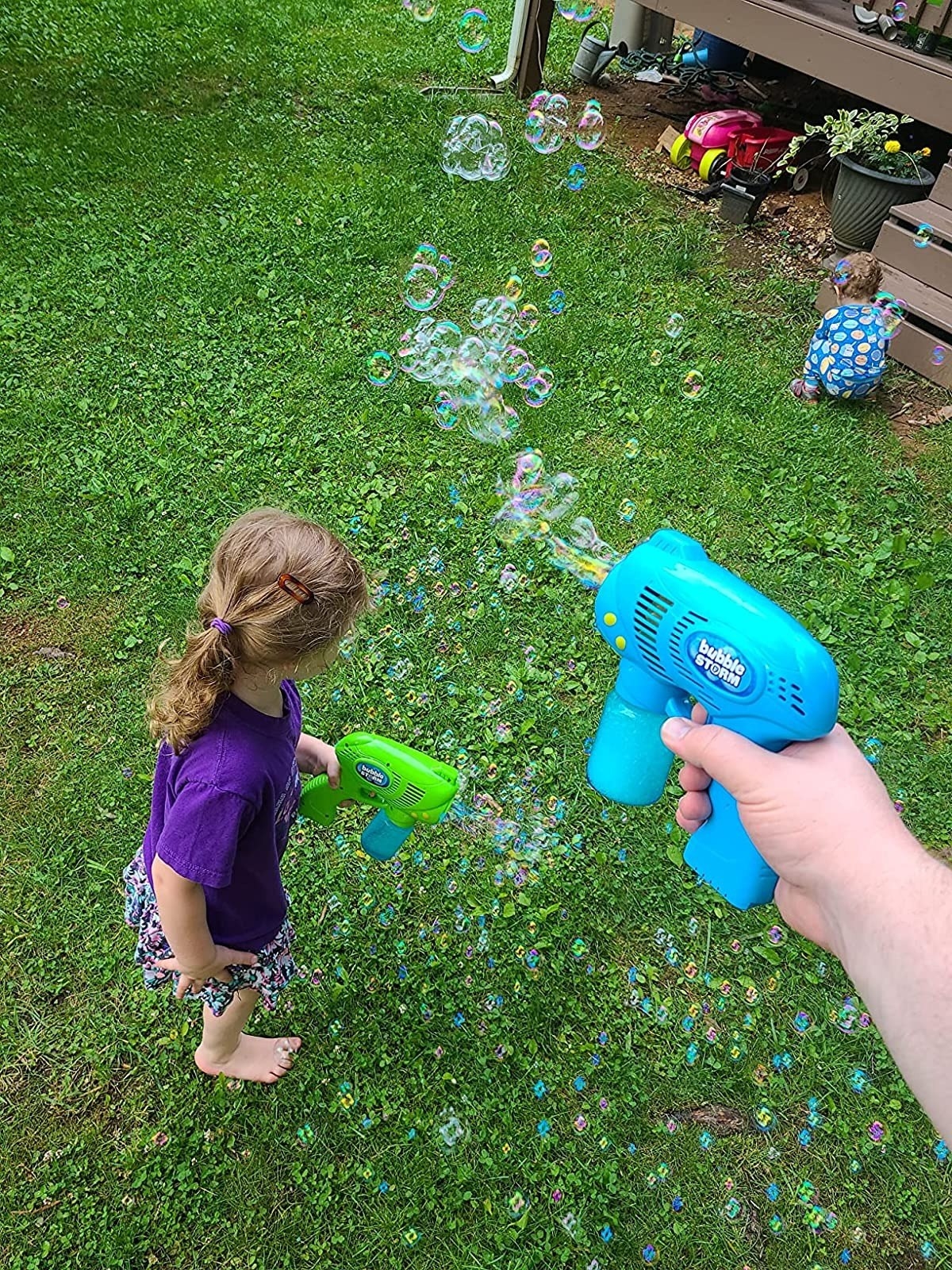 Kids play with a bubble machine