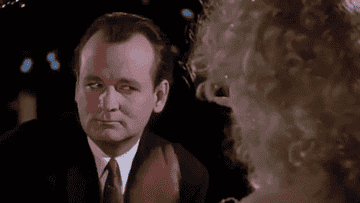 Bill Murray in "Scrooged" blocking his eyes getting poked