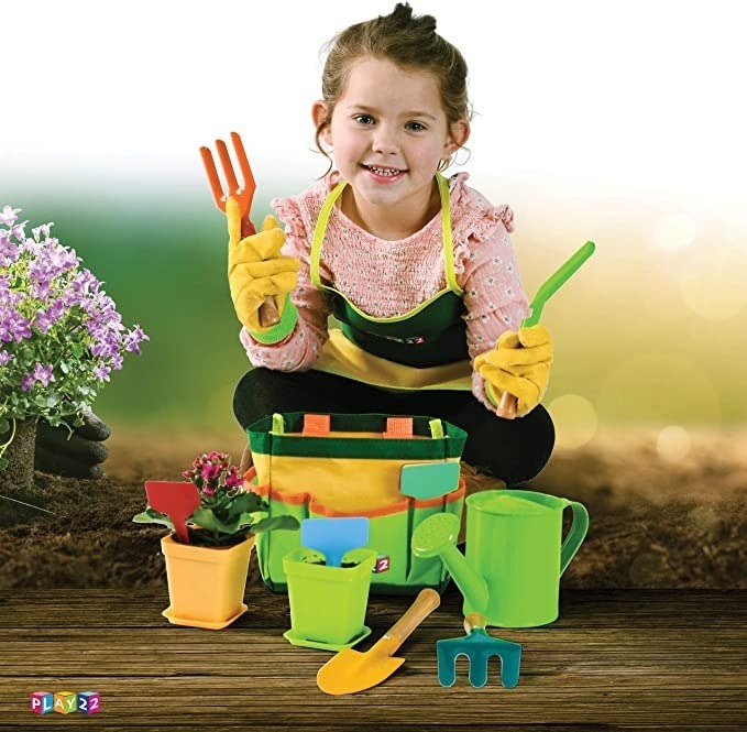 Child plays with gardening set
