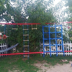 Reviewer's image of ninja obstacle course set up in backyard for scale