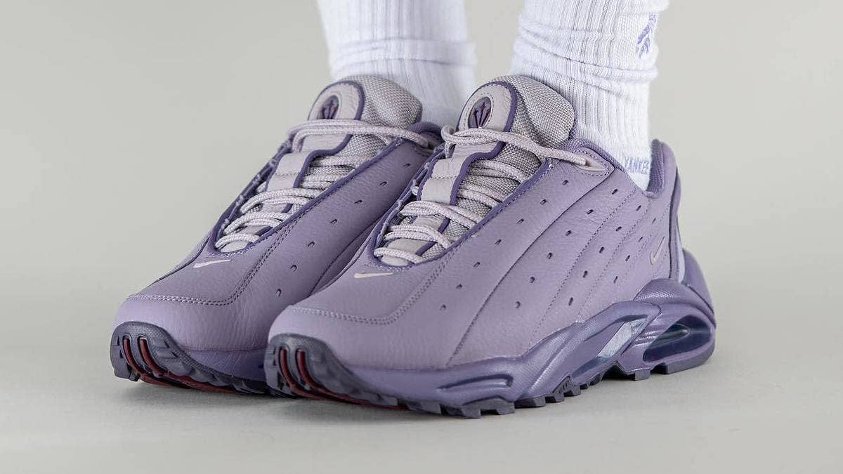 Drake's popular Nocta x Nike Hot Step sneaker collab has surfaced in a new purple colorway. Click here for a first look and the release details.