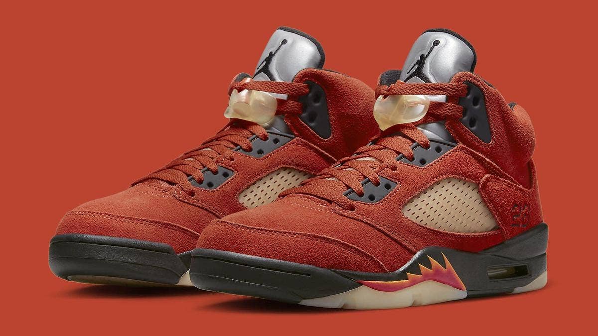 The 'Mars for Her' Air Jordan 5 draws inspiration from the 'Raging Bull' colorway, paring a bright red upper with orange accents for a women's exclusive.