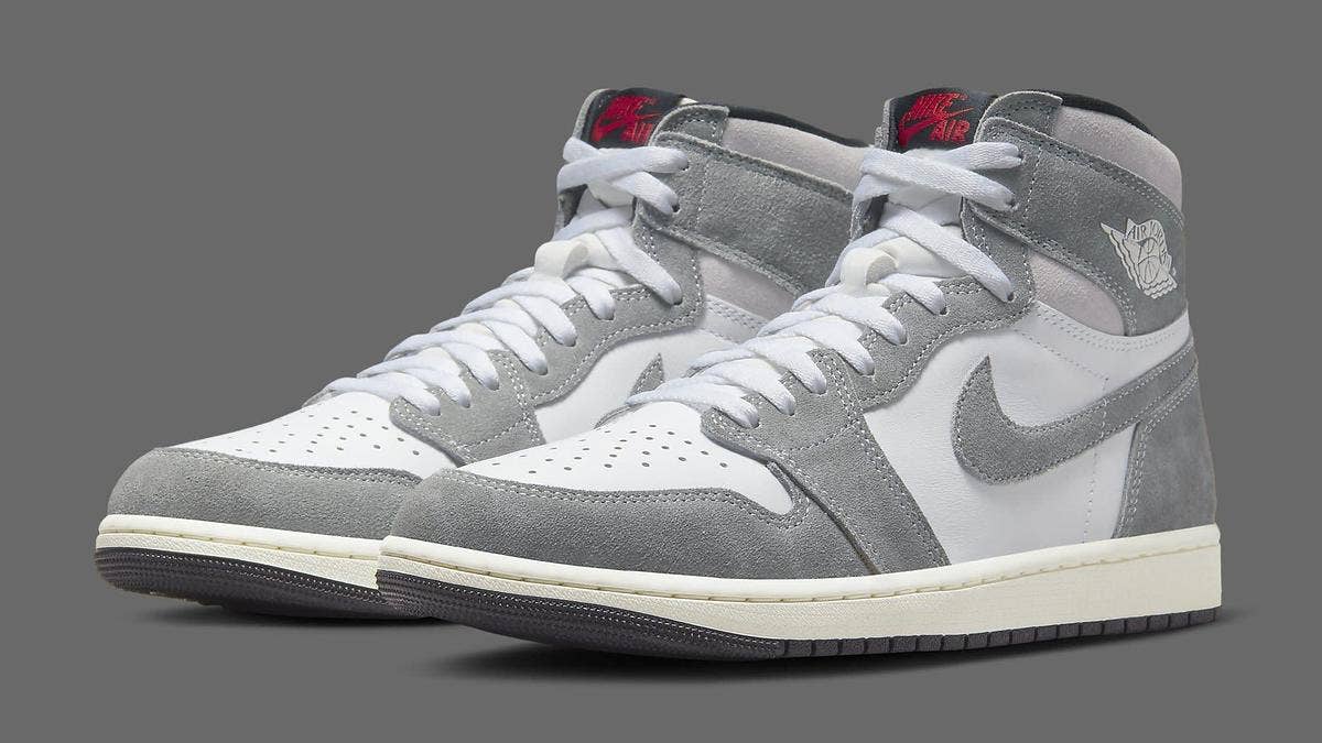 The 'Washed Heritage' Air Jordan 1 High features a greyish, faded black suede upper, along with white leather panels, a yellowed midsole, and black outsole.