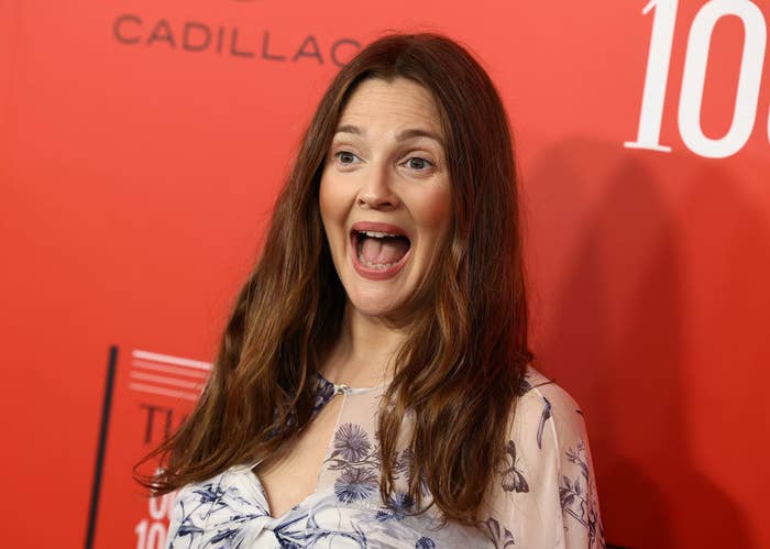 Closeup of Drew Barrymore on the red carpet reacting to the cameras