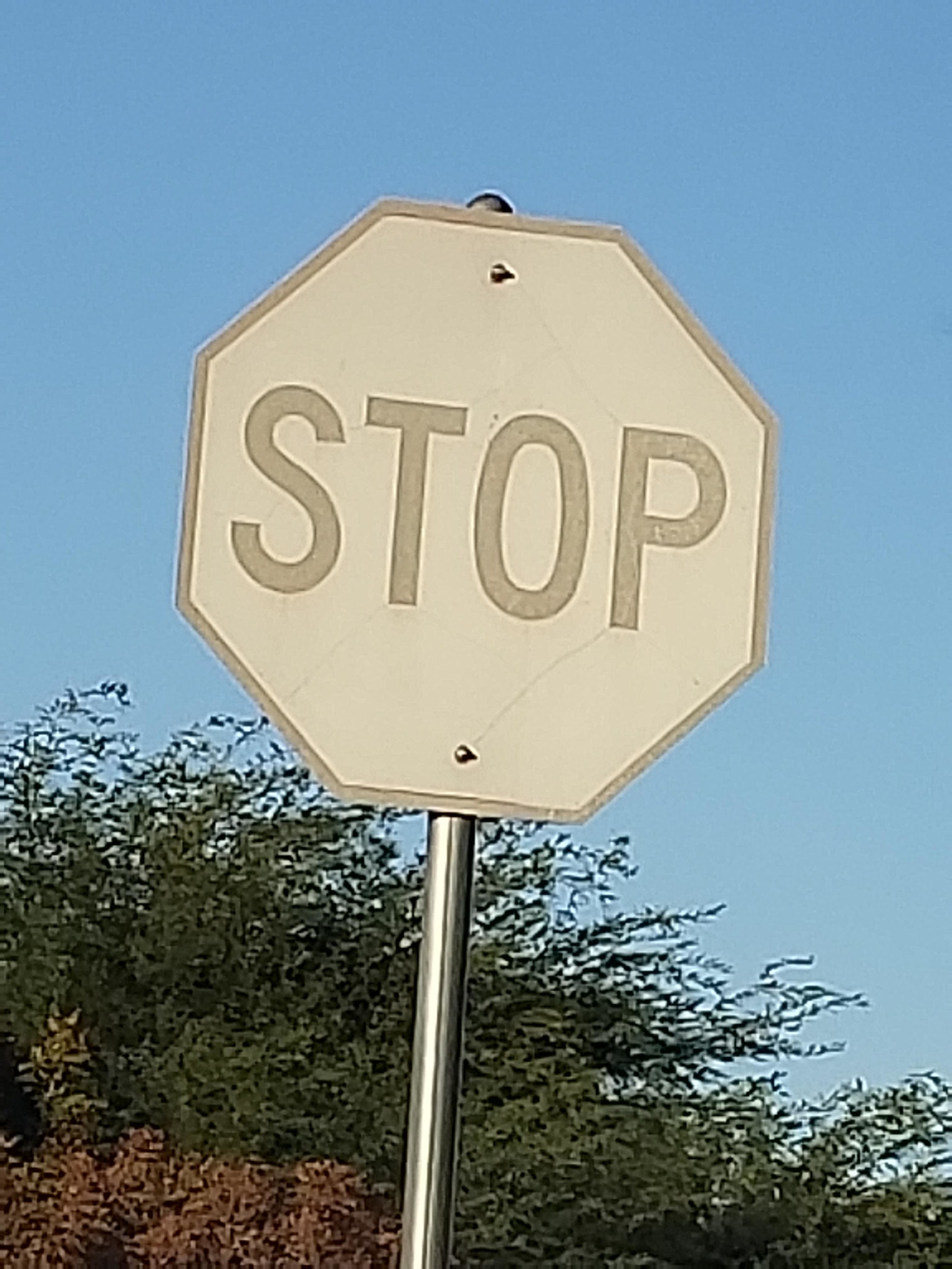 A bleached stop sign