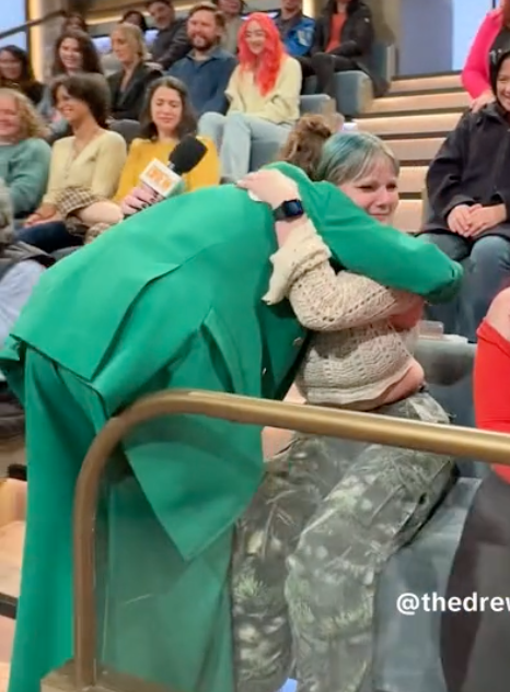Drew hugging a fan