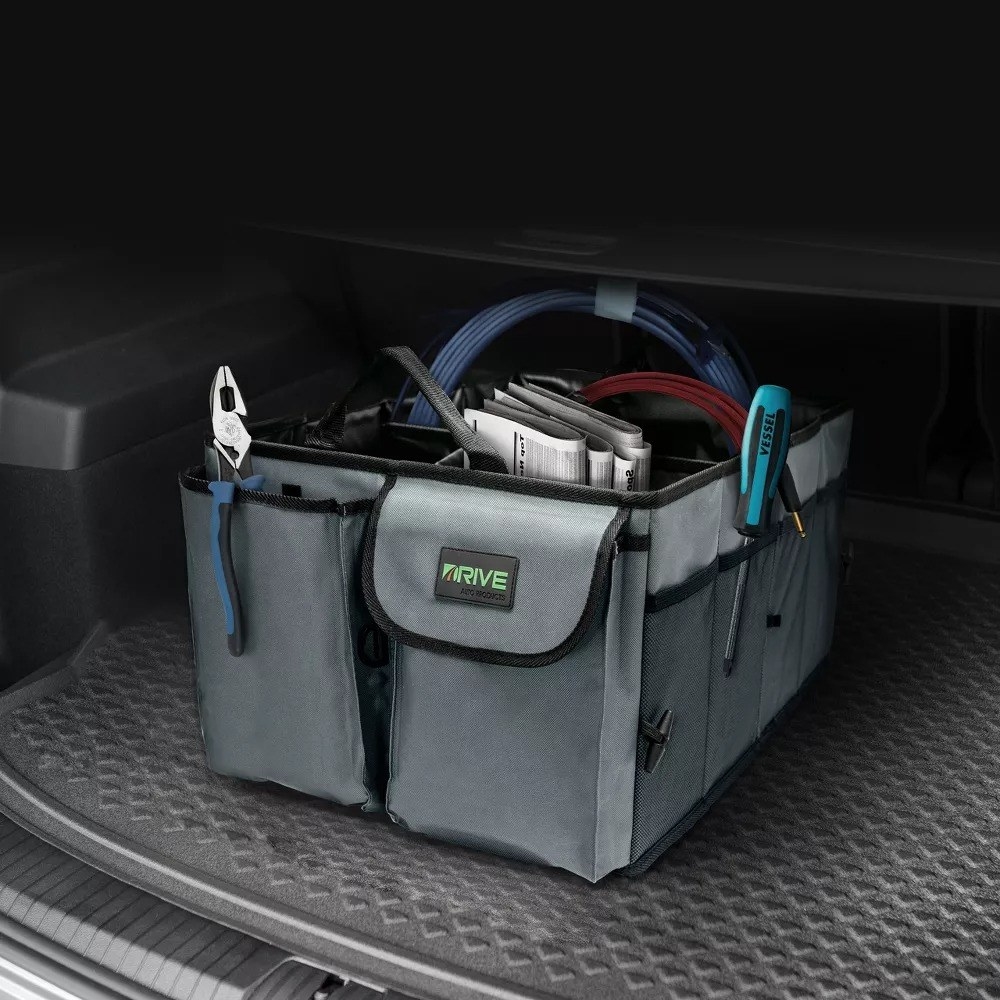 Gray car organizer with items inside in car&#x27;s trunk