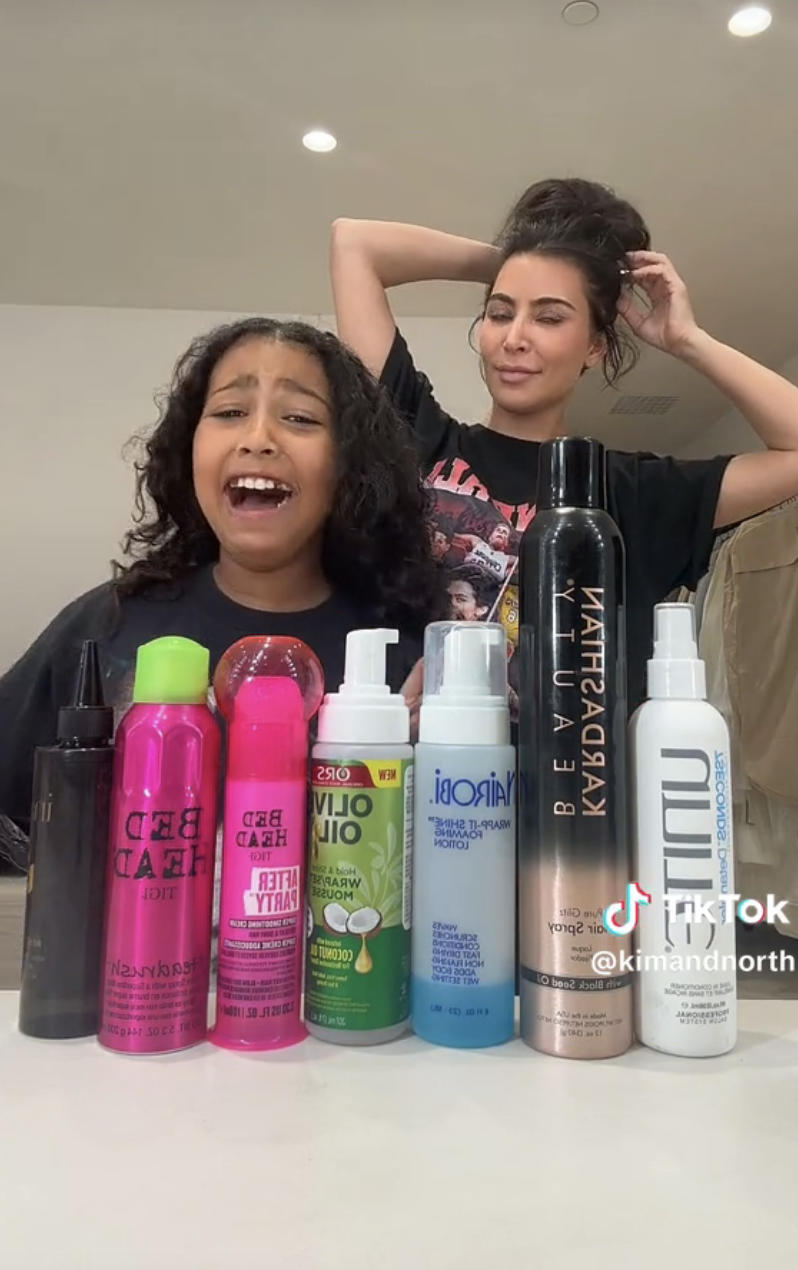 Kim and North on TikTok with a lineup of hair products in front of them