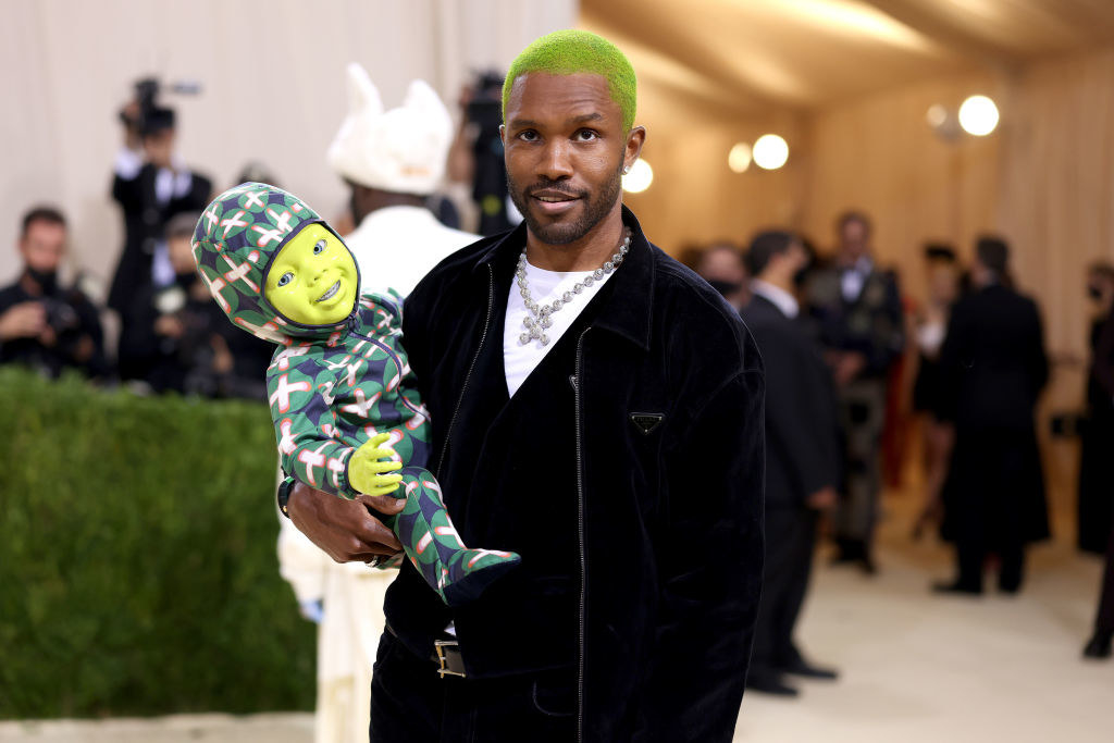 Frank at the Met Gala holding a robot baby