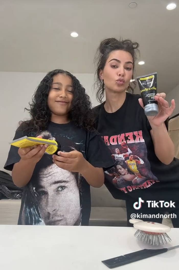 A screenshot of Kim and her daughter North doing her hair on TikTok