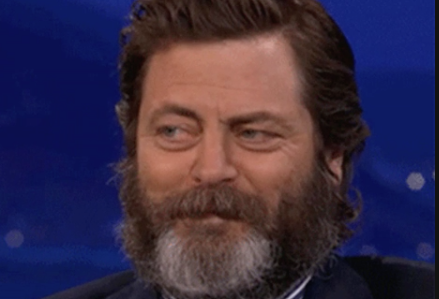 Nick Offerman smirking during an interview, creating a humorous reaction image often shared online