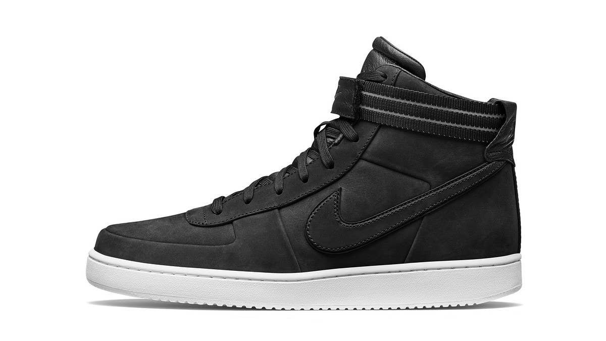 John Elliott is releasing a black colorway of his Nike Vandal collaboration via his web store. The pair features a nubuck upper and multiple straps options.