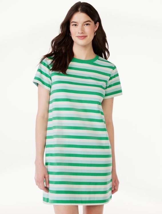a model posing in the green, blue, and white striped t-shirt dress
