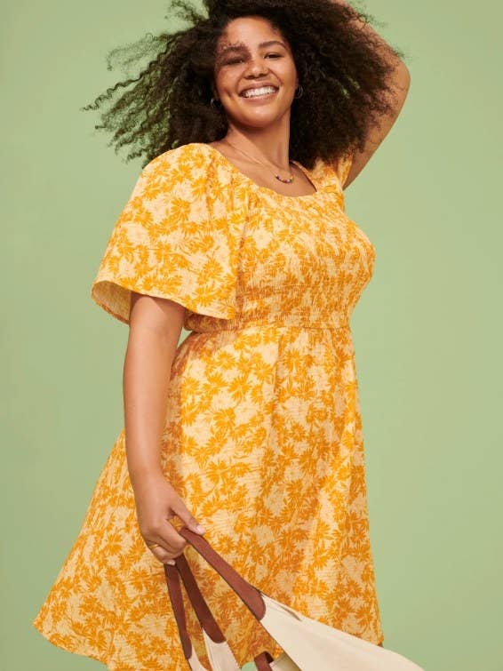 model wearing patterned yellow dress