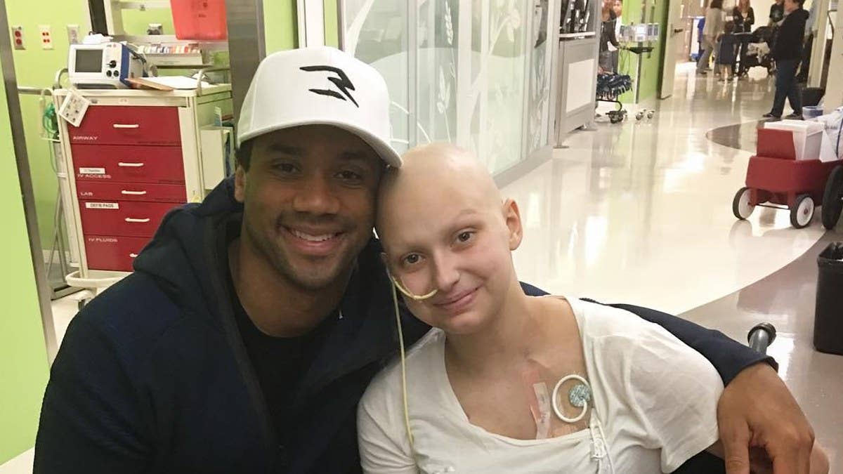Seattle Seahawks quarterback Russell Wilson donates his sneakers to patients at a children's hospital.