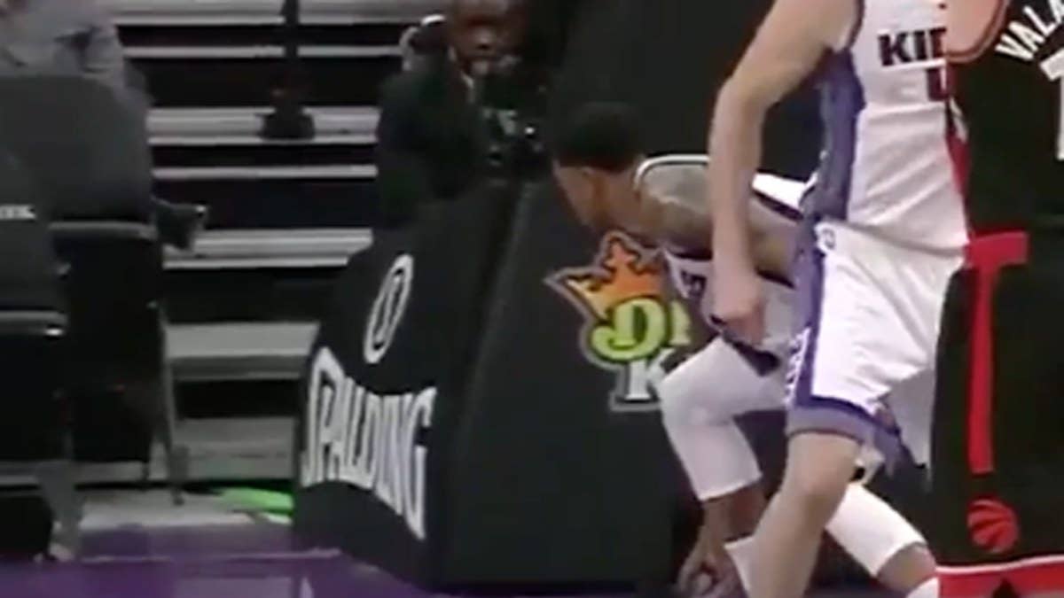 Rudy Gay tosses DeMar DeRozan's Nikes into the crowd, hitting a fan in the face.