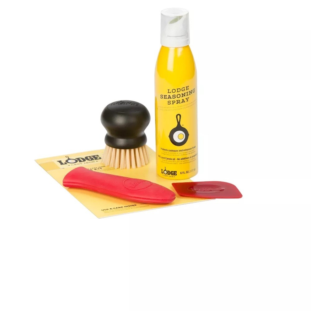 Contents of cast iron kit: red scraper, red silicon handle holder, yellow spray bottle and black brush