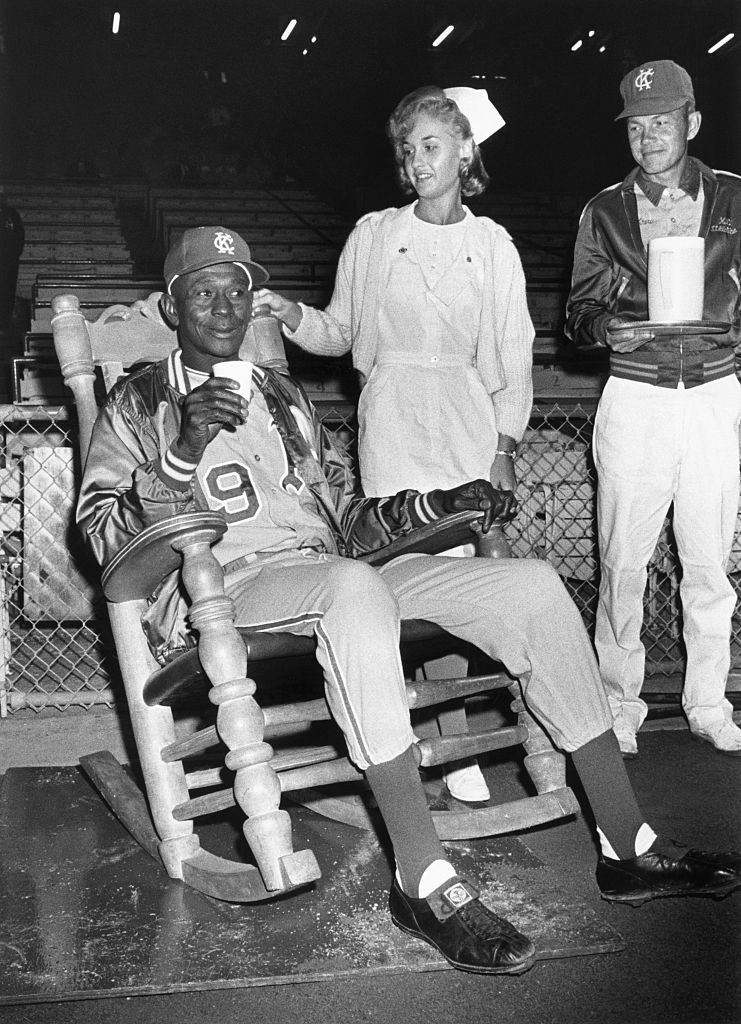 Satchel sitting in a rocking chair, being tended to by a nurse