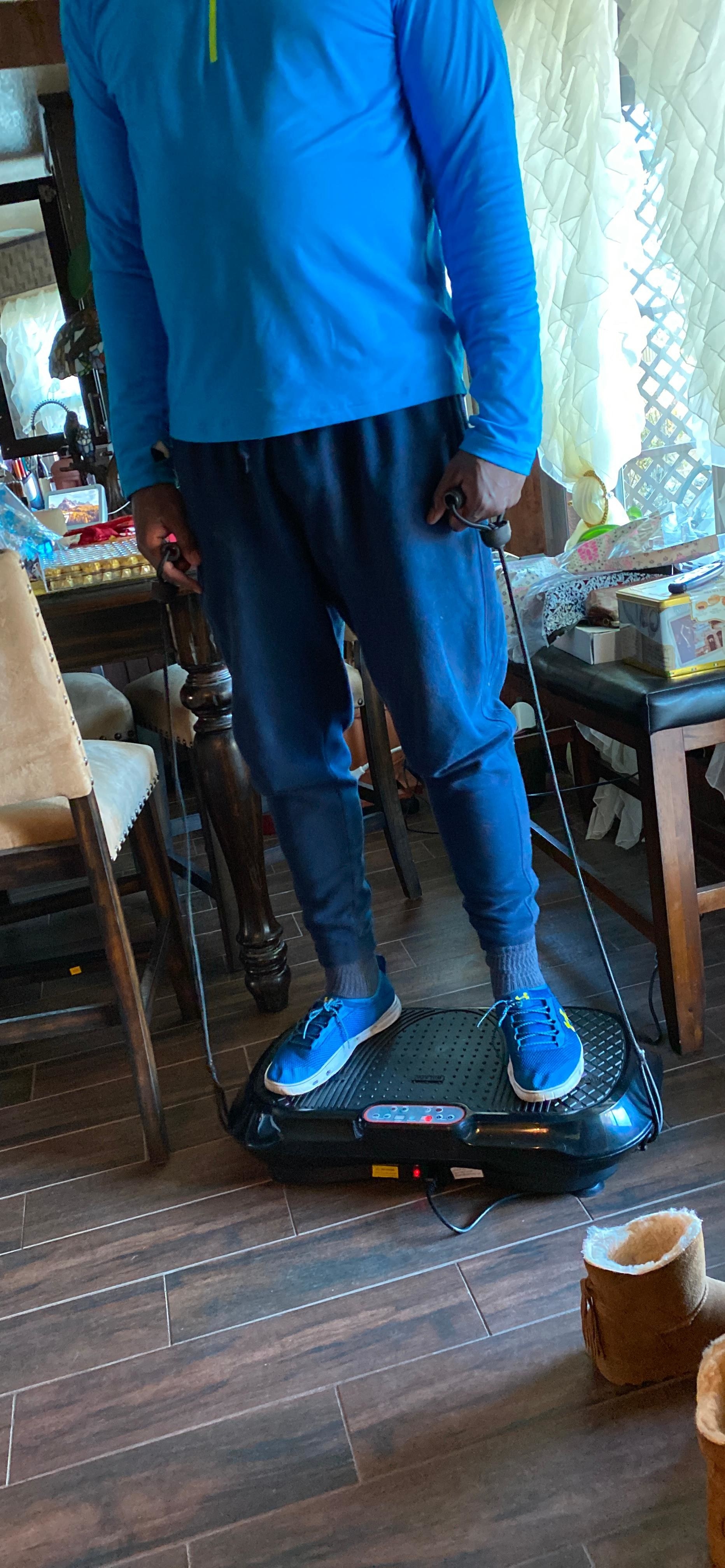 a reviewer standing on their vibration plate
