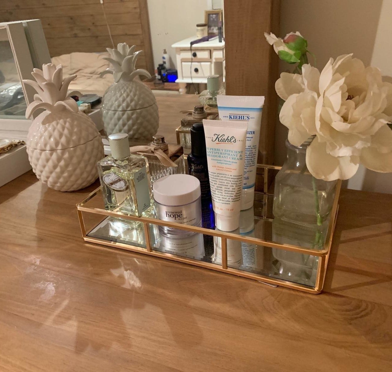 Reviewer&#x27;s photo of the tray in the color Gold, displaying skincare and fragrance items
