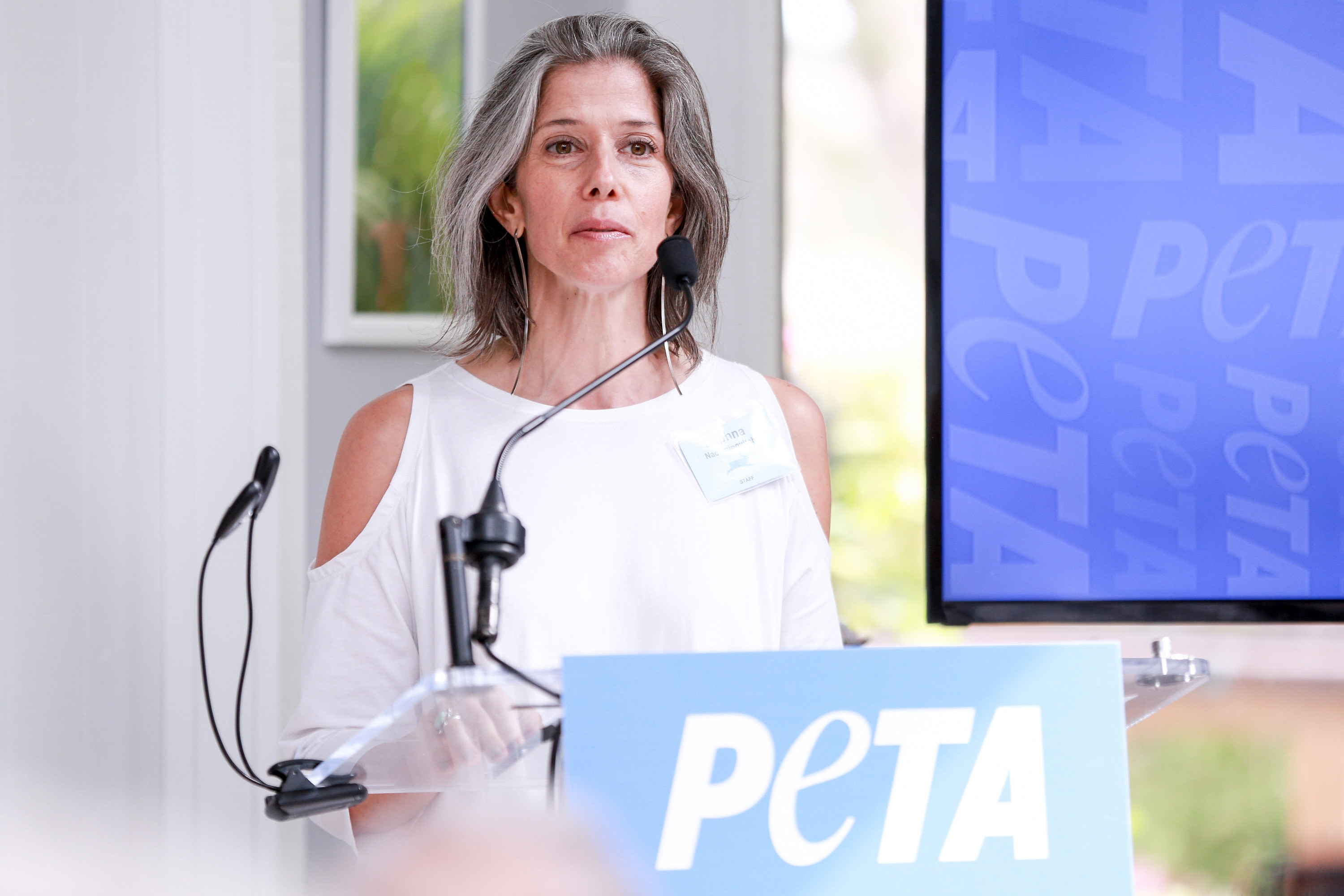 Daphna Nachminovitch speaking at a PETA event