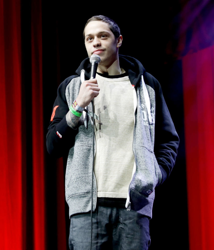 Pete holding a microphone onstage