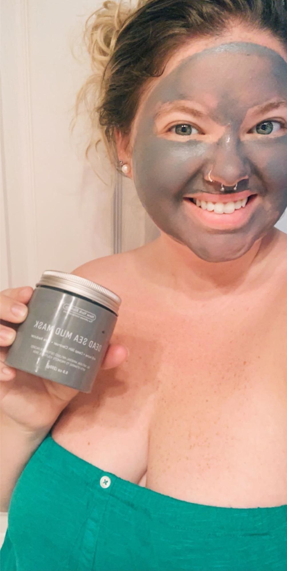A reviewer wearing the mud mask