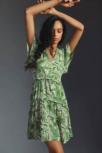 model wearing a green and white patterned dress