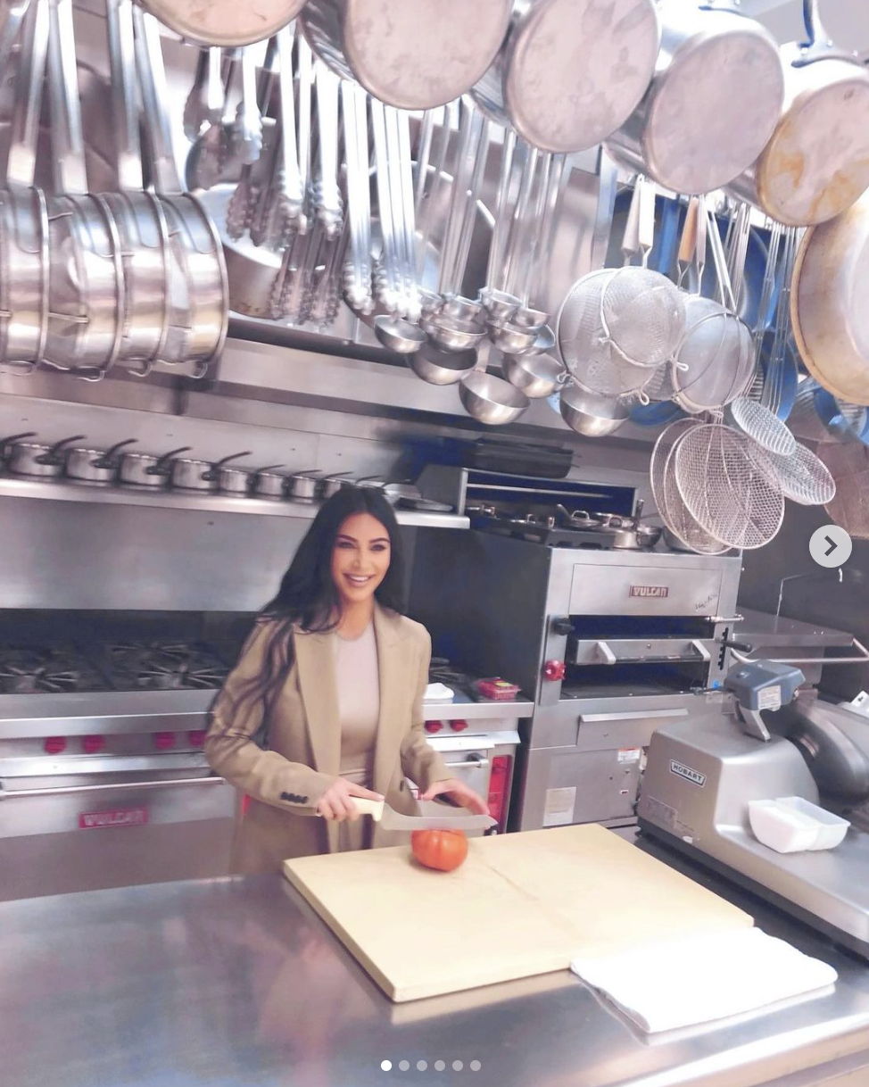 Kim looking as if she's about to slice a tomato