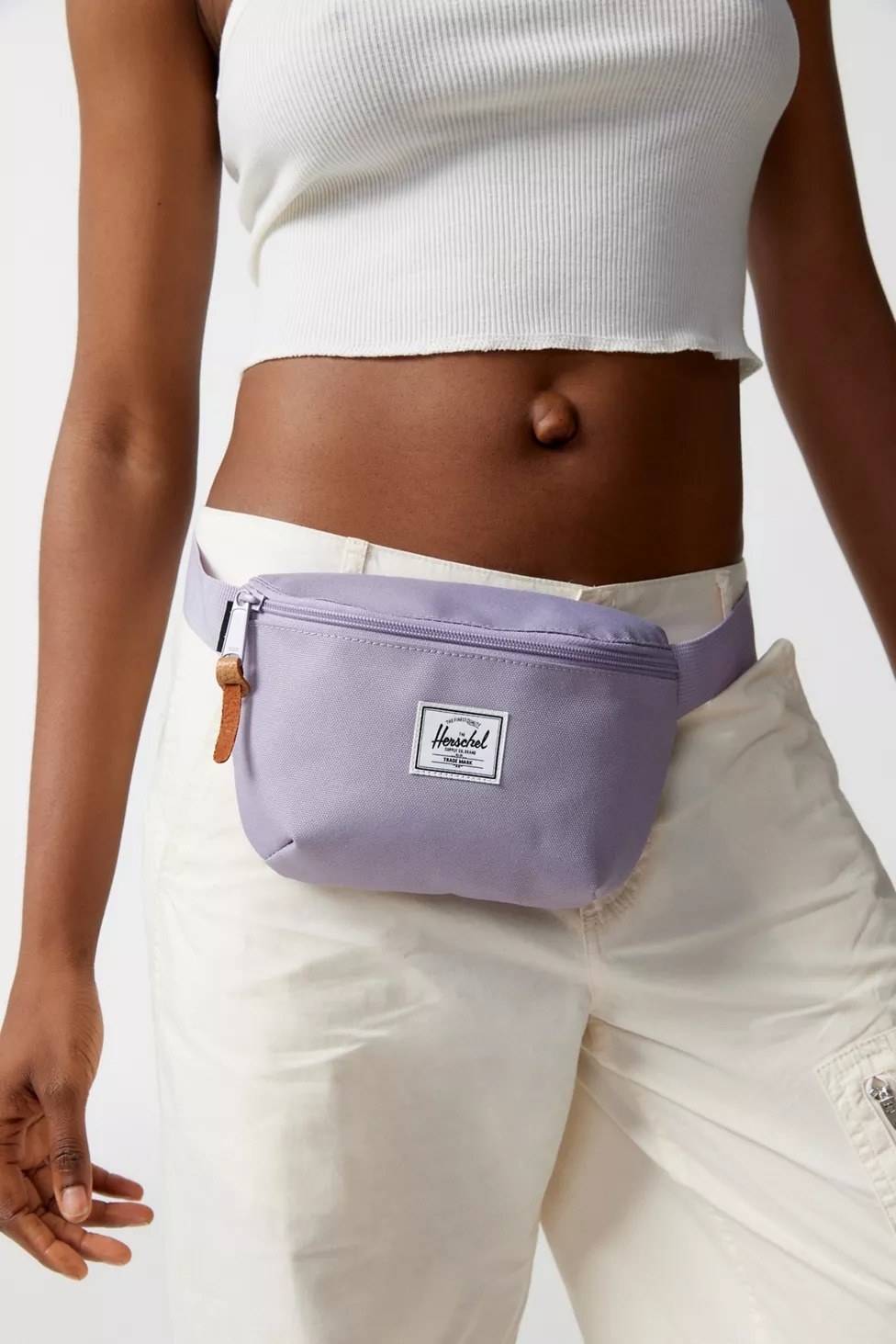 model wearing purple belt bag around waist