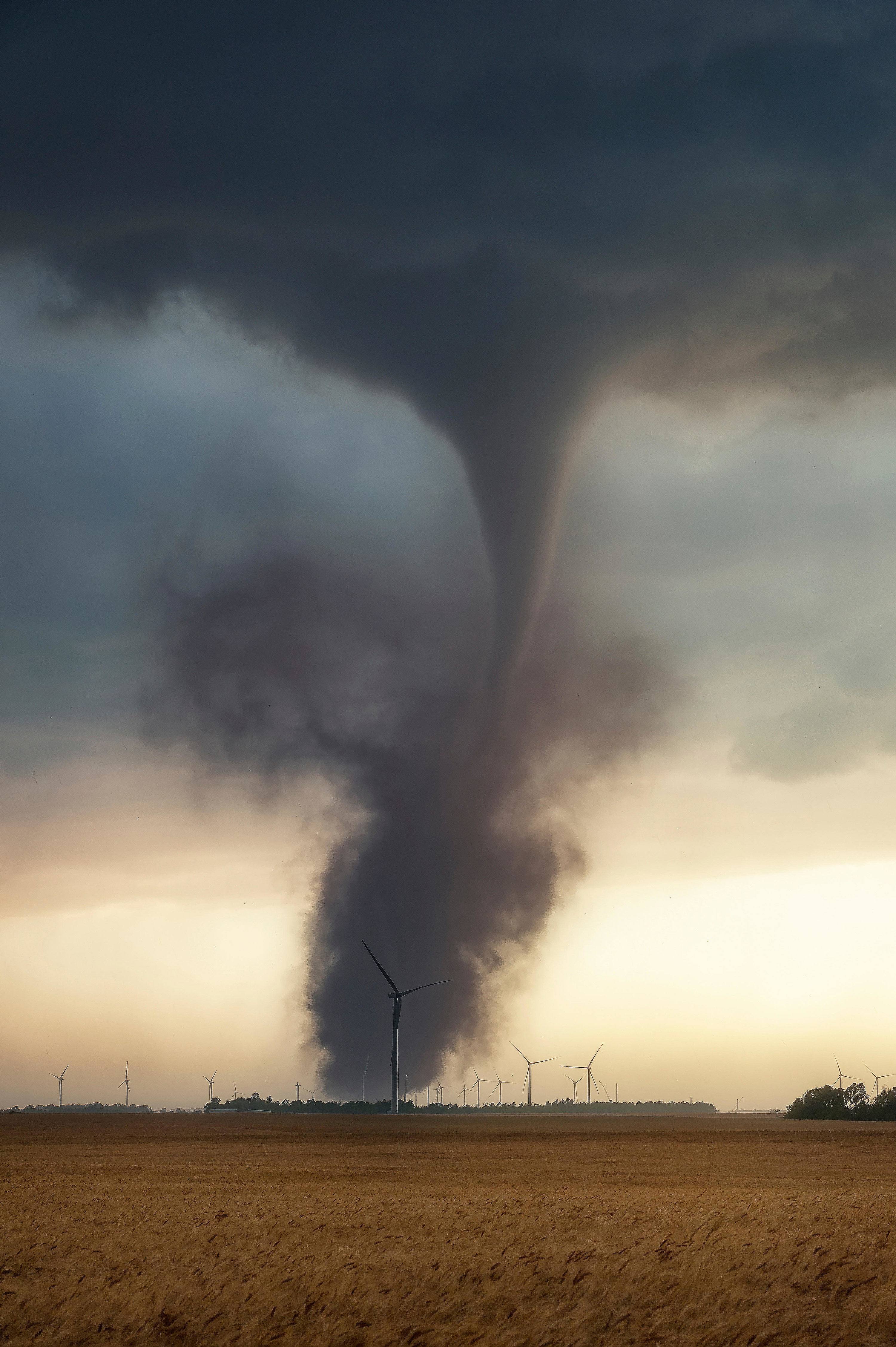 A tornado over a wind turbine