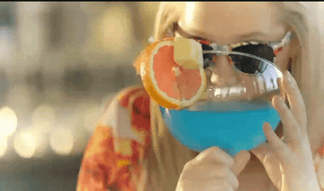 gif of Amy Shumer drinking a large tropical drink