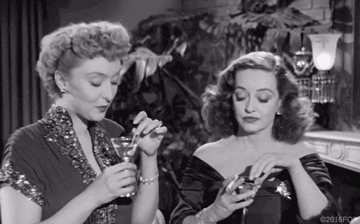 gif of Bette Davis and another old hollywood actor drinking