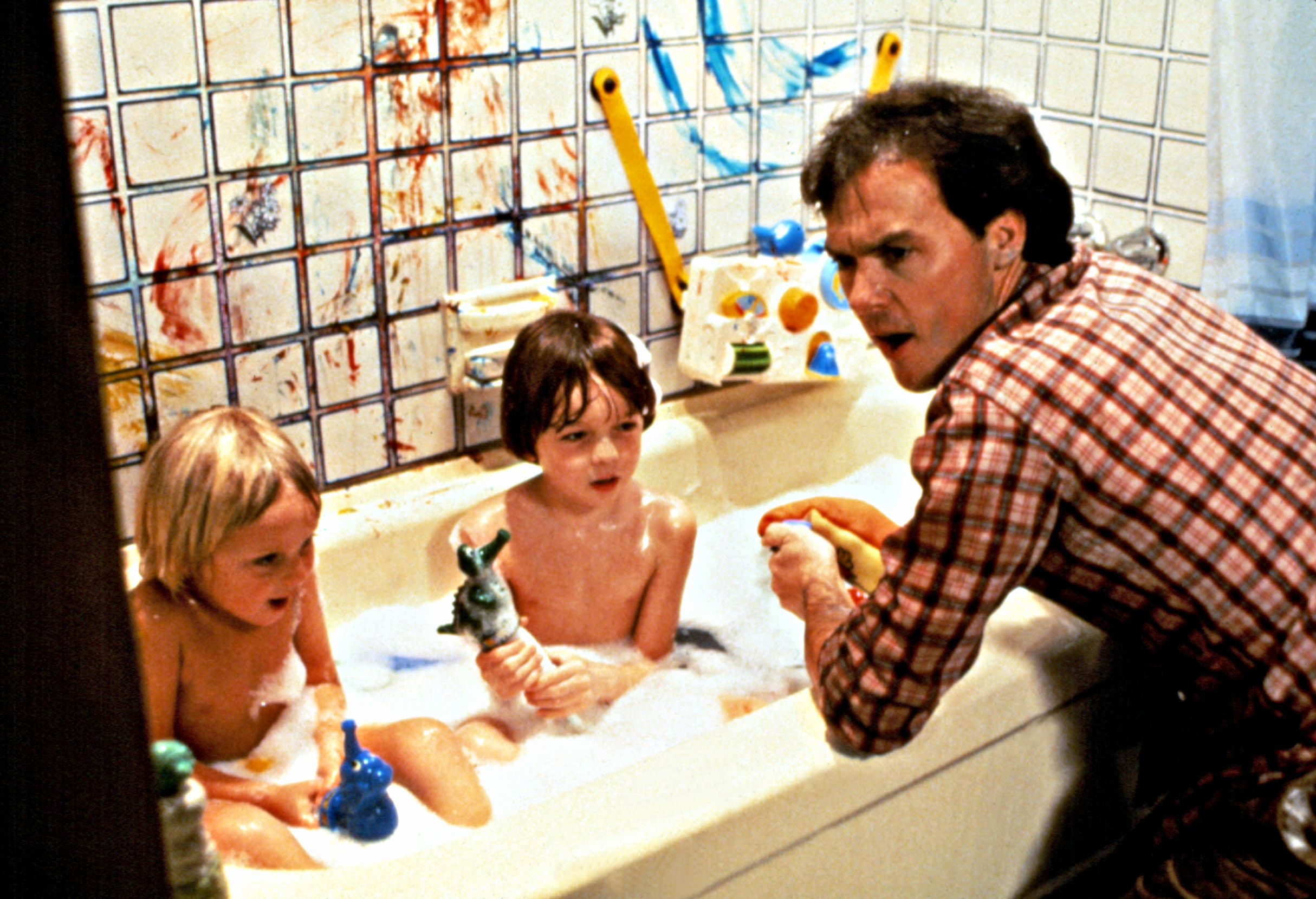 Michael Keaton supervises during bath-time as Taliesin Jaffe and Frederick Koehler sit in the tub in a scene from Mr. Mom