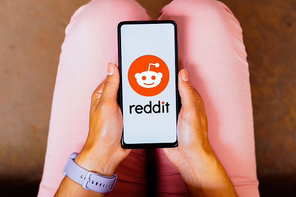 A phone opened to the Reddit app