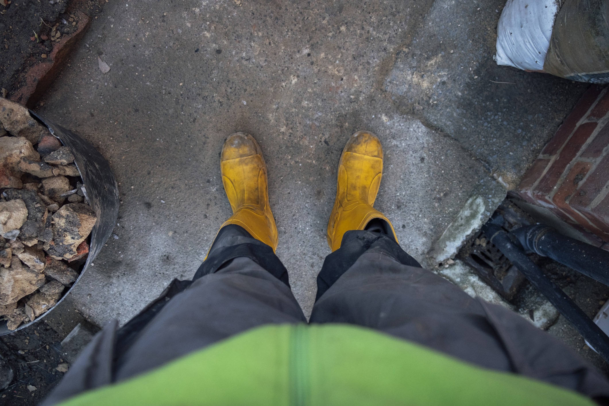 A person&#x27;s yellow mud boots