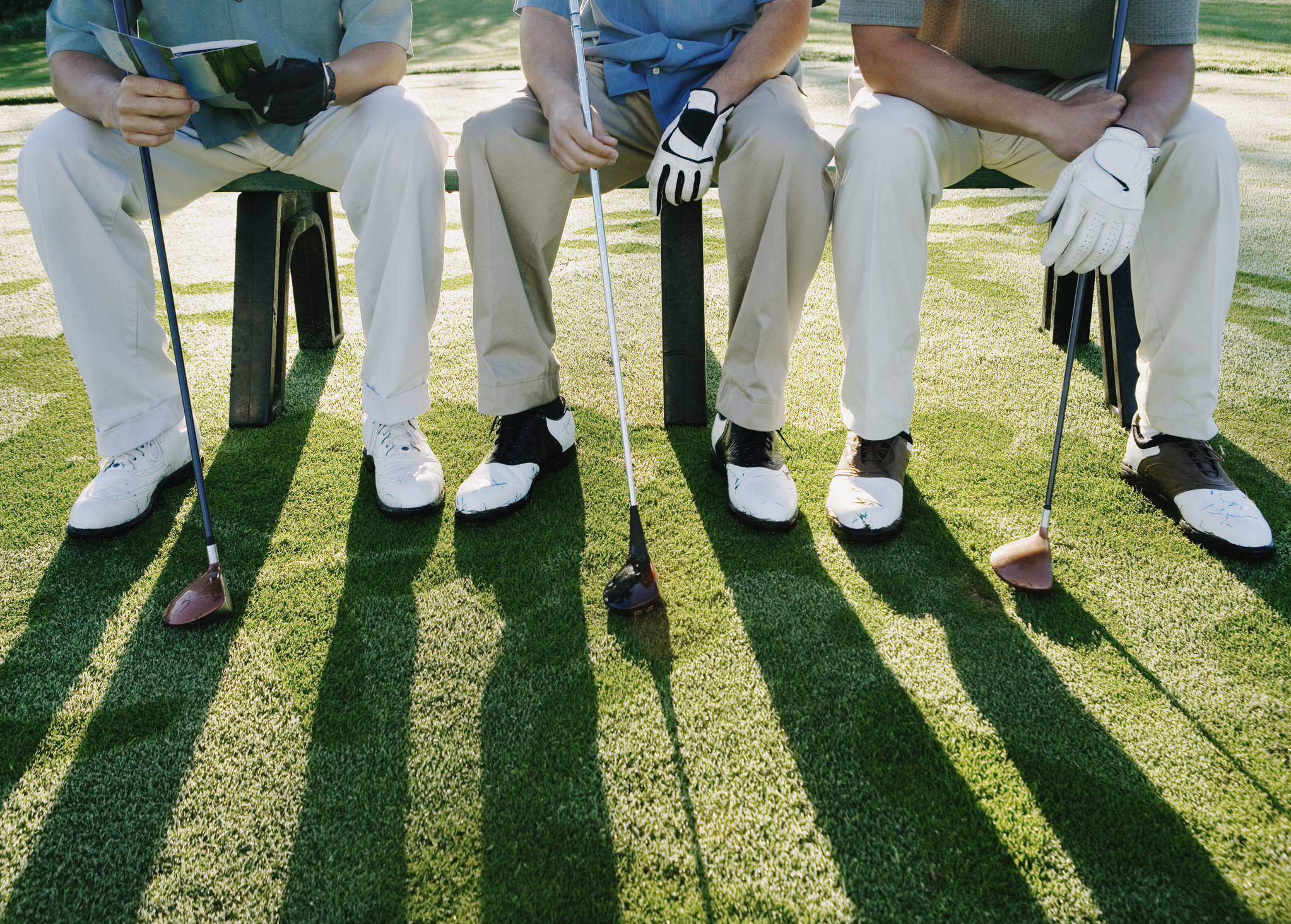 Golfers sitting on a bench
