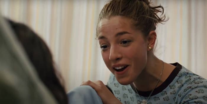 A closeup of Olivia Thirby talking to another person in a TV scene