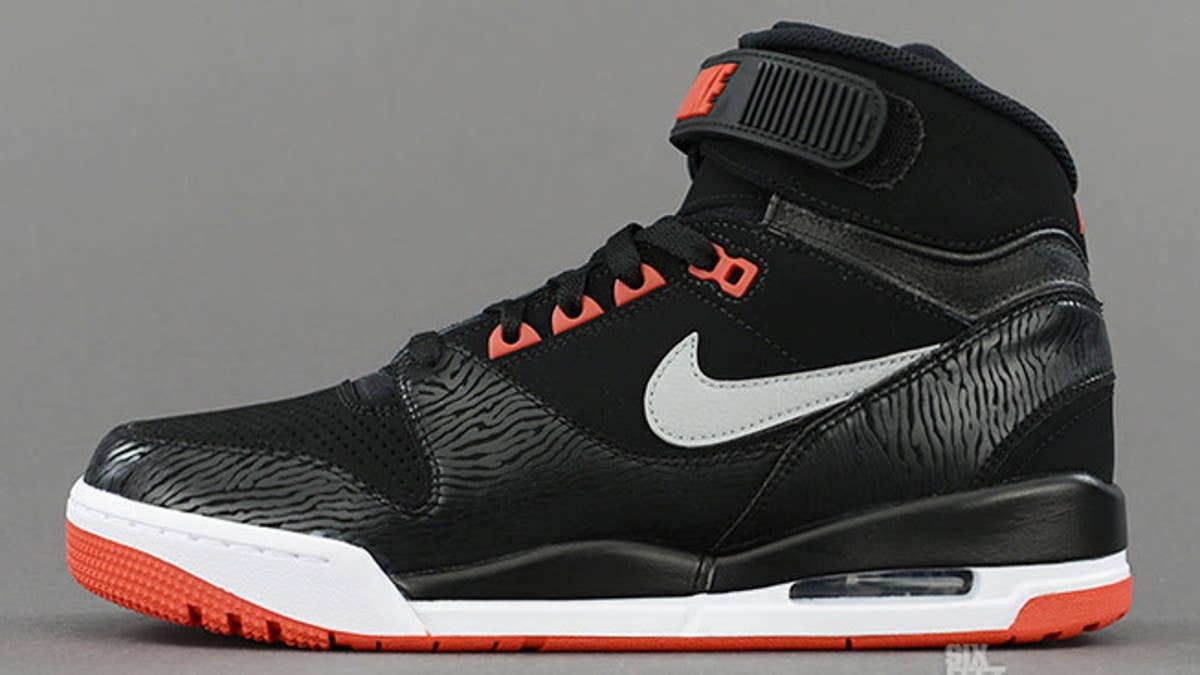 Nike Sportswear drops another colorway of the retro Air Revolution this week, this time arriving in Black / Silver / Red.