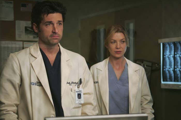 Patrick Dempsey as Dr. Shepherd standing next to Dr. Meredith Grey in a hospital room in a scene from the show
