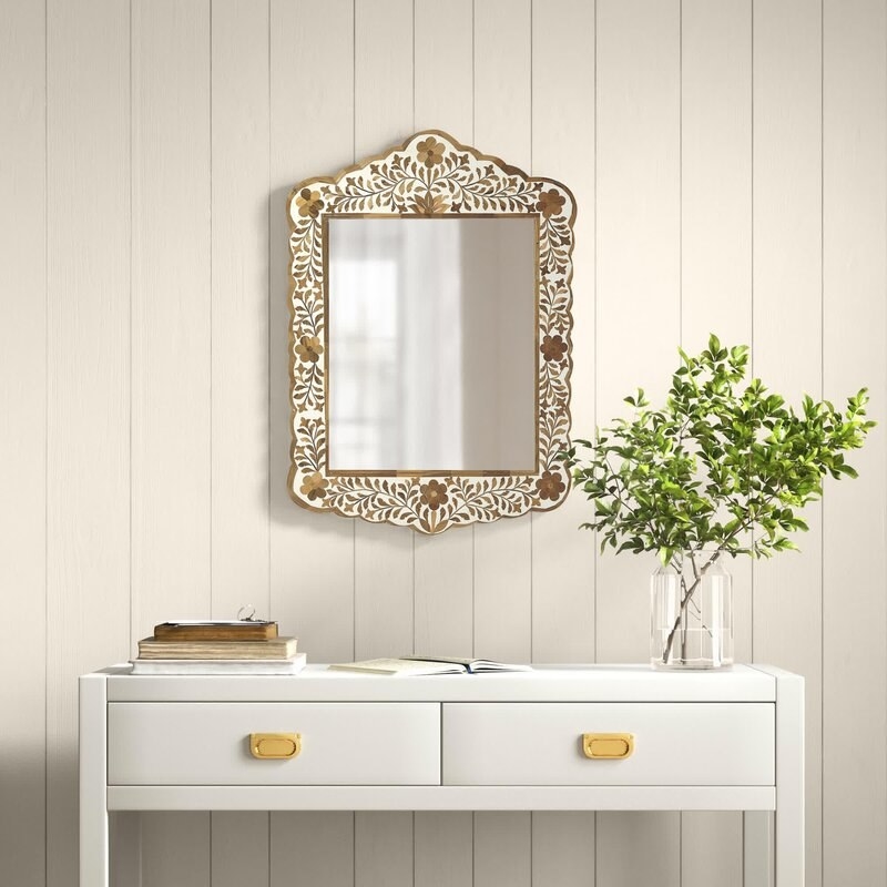 the brown and white inlay mirror above a desk/vanity