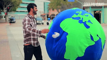 person hugging someone dressed as the earth