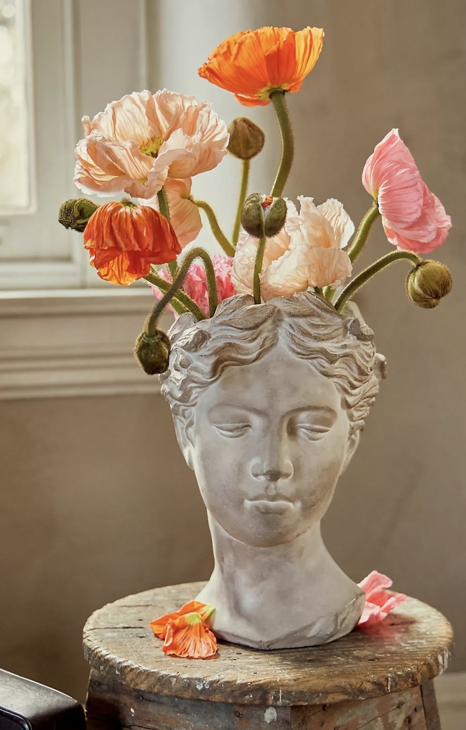 The bust pot with flowers bursting out of top head opening