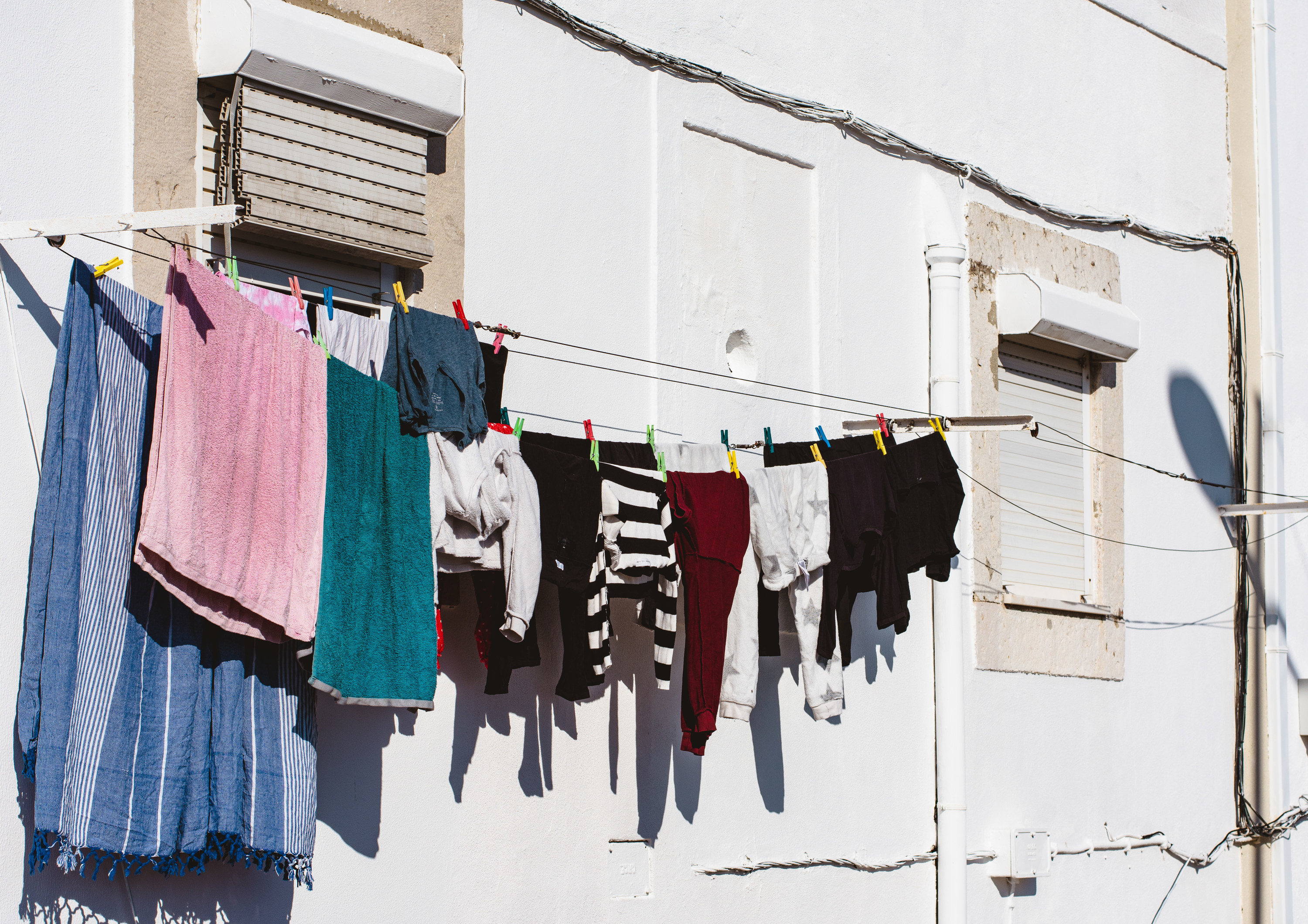 laundry hanging up to dry on the side of a building