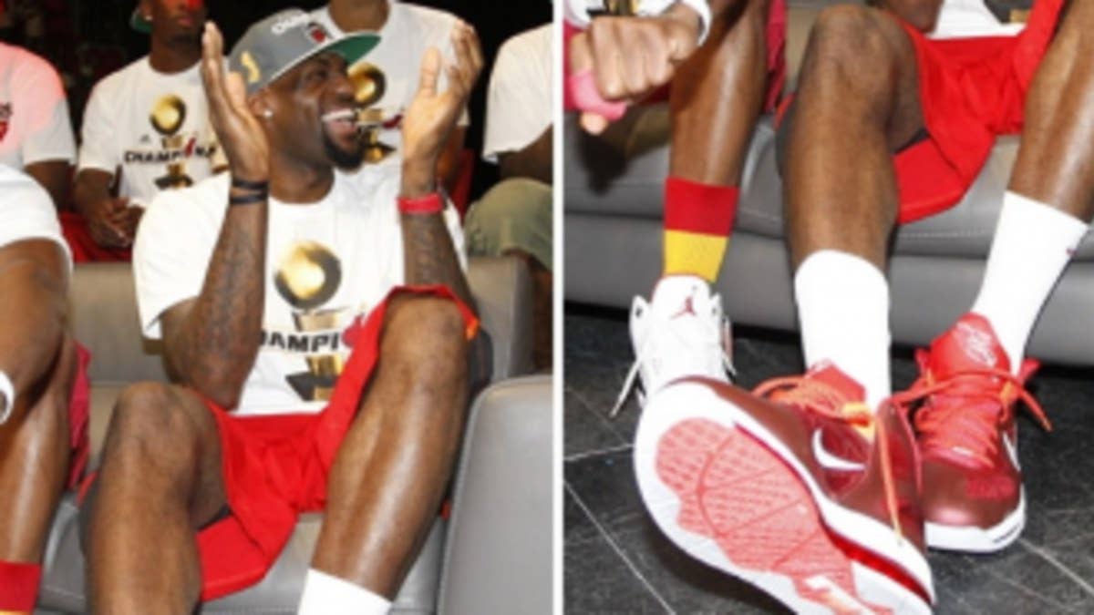 LeBron laces up his low-top sig for the Heat's victory celebration.